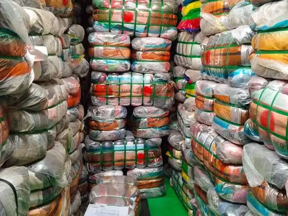 An aisle of plastic-wrapped clothing bales
