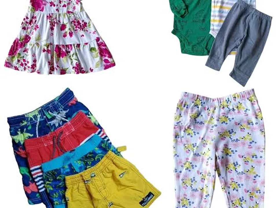 Children's dress, tops and trousers laid flat