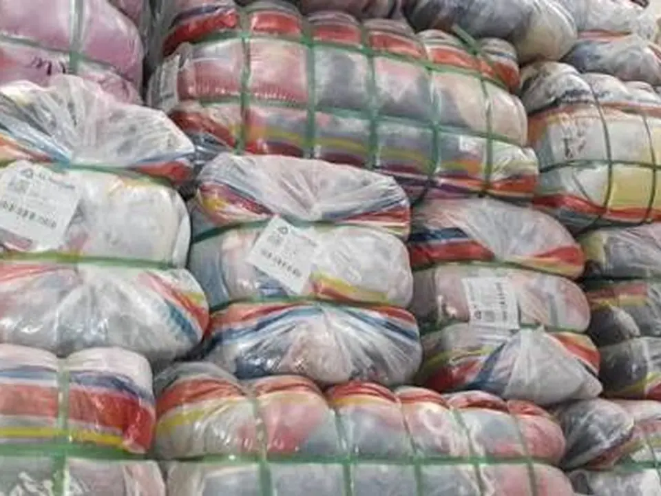 Stacks of colourful wrapped clothing bales