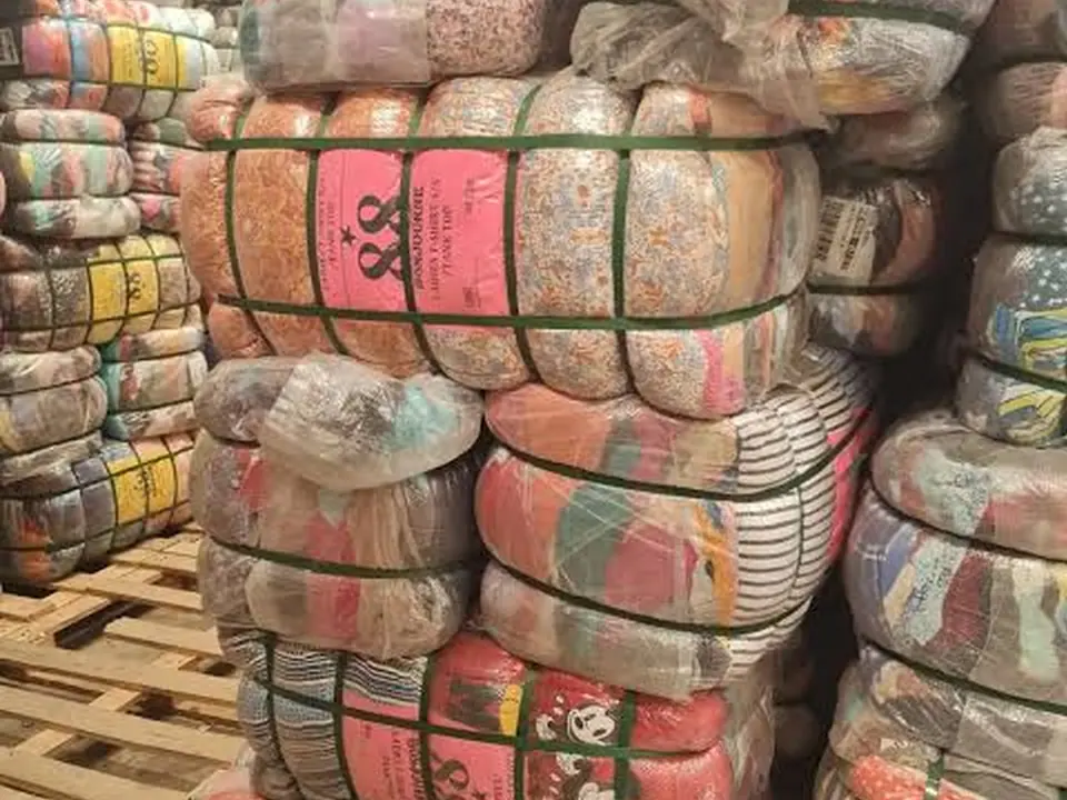 Wrapped bales of patterned clothing