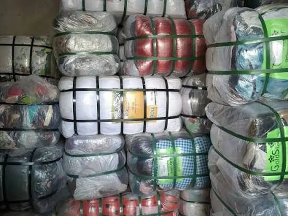 Wrapped bales with folded shirts visible