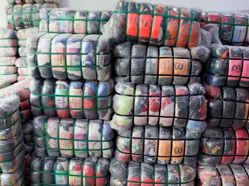 Stacks of mixed wrapped clothing bales